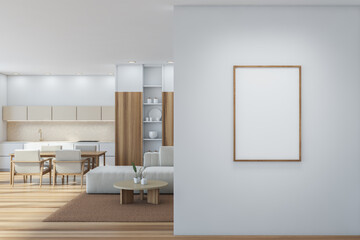Fototapeta na wymiar Placard on white wall near studio kitchen interior with open shelf, beige