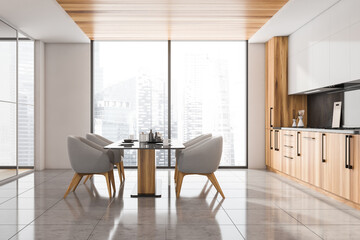 Side view of panoramic kitchen with grey chairs, wooden elements