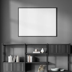 Empty framed canvas with bookshelf at the dark grey waiting room wall