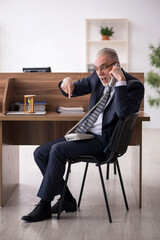 Aged male employee in time management concept