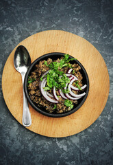  Georgian dish Kuchmachi in a plate with onions 