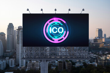 ICO hologram icon on billboard over panorama city view of Bangkok at sunset. The hub of blockchain...