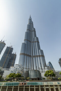 Burj Khalifa tower and green garden in the sun Dubai Downtown, UAE
