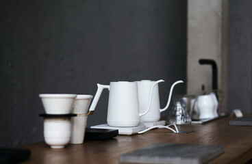 White electric kettle and coffee set with coffee filter on wooden counter