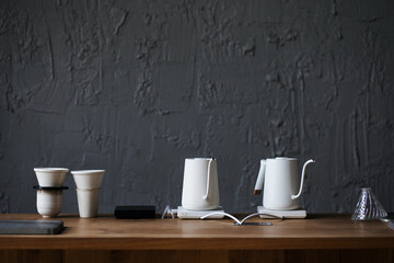 White electric kettle and coffee set with coffee filter on wooden counter