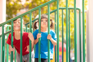 Child playing on the outdoor playground. Kids play in school or kindergarten yard.