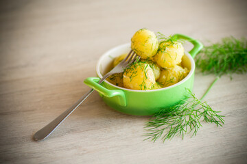boiled early potatoes with butter and fresh dill in a bowl