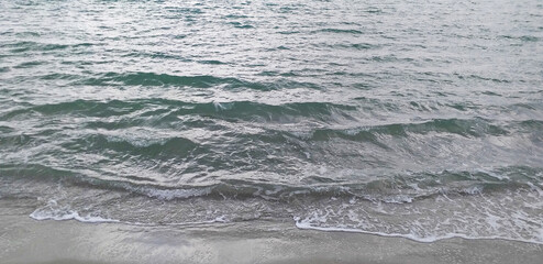 Sea waves roll on the shore, a wide background