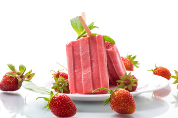 homemade strawberry ice cream on a stick made from fresh strawberries in a plate
