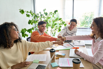 Young happy laughing creative startup team four multiethnic coworkers diverse students work...