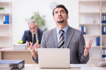 Two male employees working in the office