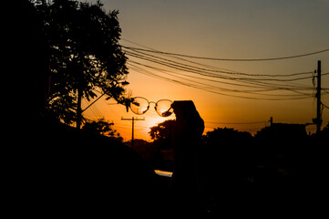 silhouette of a person sitting on a chair at sunset 