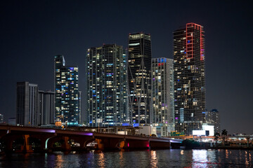 Night photo highrise condos Downtown Miami with bridge and bay