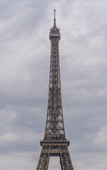 Fototapeta na wymiar Paris, France - 25 06 2020: Champ-de-Mars: View of Eiffel Tower from the Champ-de-Mars