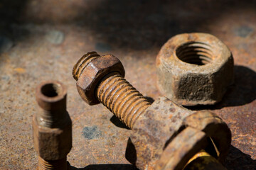 old rusty bolt, iron rod with screw threads. Rusted mechanical components. threaded bolt and nut. dismantling concept, difficult to unscrew, non-removable. selective focus, close-up, macro