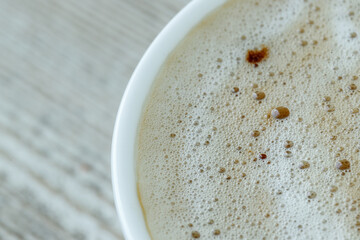 Milk foam in coffee close-up, macro photo of a drink