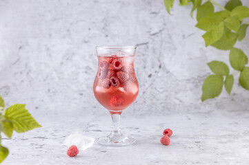 A glass of fresh raspberry lemonade with ice cubes.Summer drinks