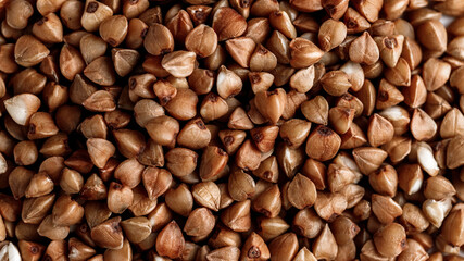 Macro photo of buckwheat groats. Many small objects close up. Healthly food