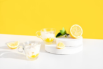 Lemon mousse or ice cream in a glass cups on yellow background. Traditional Italian recipe of lemon...