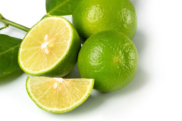 Close up natural fresh lime with sliced, green leaf isolated on white background..