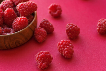 Raspberry berries close-up on a pink background