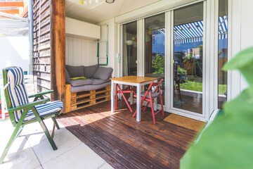 Cozy and homely veranda with little garden, summer time