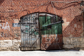 Old barn doors, with peeling paint, with two large metal locks on them. Pattern © elenarostunova
