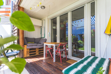 Cozy and homely veranda with little garden, summer time - obrazy, fototapety, plakaty