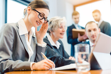 Young business woman working with her colleagues in meeting