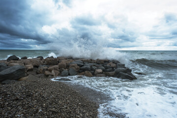 Waves on pebble beach. Storm at sea.