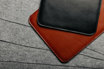 Leather tablet od laptop cases on a grey felt background