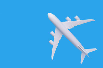 Naklejka na ściany i meble model of passenger plane on blue background.Travel concept