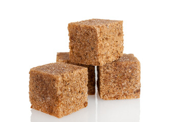 Brown dark sugar produced from cane, refined cubes, isolated on a white background