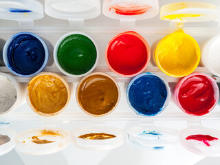 Cans of paint, top view, water-soluble gouache, acrylic paints, watercolor, drawing and painting