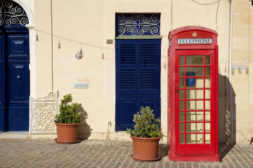 MARSAXLOKK, MALTA - 03 JAN, 2020: Classic red British telephone box at the traditional fishing village of Marsaxlokk