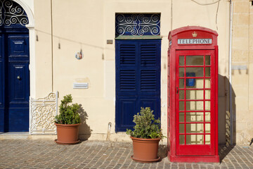 MARSAXLOKK, MALTA - 03 JAN, 2020: Classic red British telephone box at the traditional fishing...