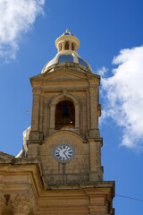Fototapeta na wymiar DINGLI, MALTA - 02 JAN, 2020: Detail of old, historic and authentic Christian chapel St. Mary's Parish Church in Dingli with blue sky in the background on a sunny winter day