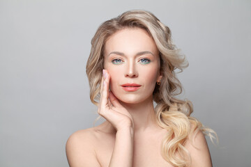 Beauty portrait of a smiling young blonde woman, facial treatment and skin care concept