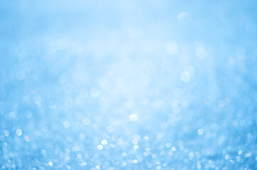 Naklejka na ściany i meble Light blue abstract bokeh background in a white luminous haze