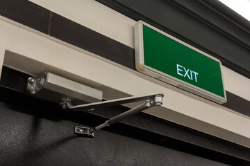 Exit sign on the door. Close up Exit sign on door in the building. Evacuation exit.