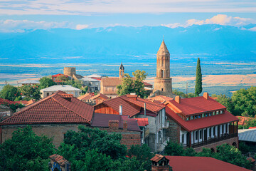 Obraz premium View of Sighnaghi in winery region of Georgia, Kakheti, during sunset in summer with Caucasus mountains in the background