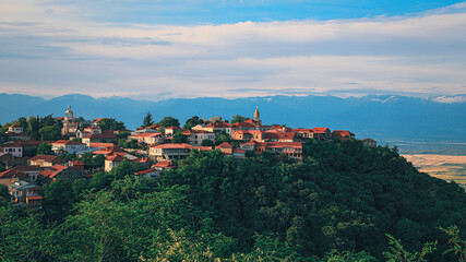 Fototapeta na wymiar View of Sighnaghi in winery region of Georgia, Kakheti, during sunset in summer with Caucasus mountains in the background