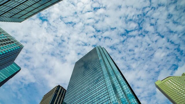 A timelapse of clowd at the building in the business town wide shot panning