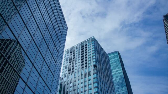 A timelapse of clowd at the building in the business town wide shot tilt