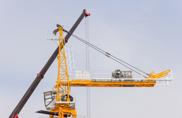 Tower crane assembly. Installation of a construction crane before starting construction. Construction crane assembly stage