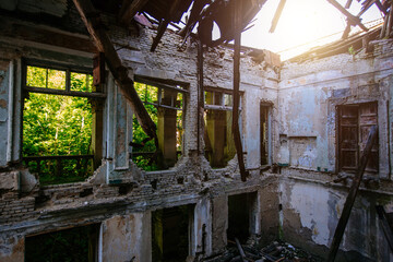 Ruined mansion hall interior overgrown by plants. Nature and abandoned architecture, green post-apocalyptic concept