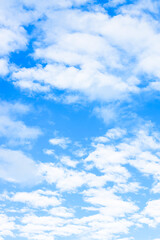Blue sky with clouds, unfocused. Blue sky background with tiny clouds