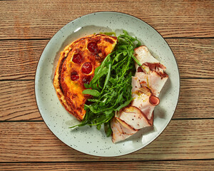 French omelette with baked ham and fresh arugula