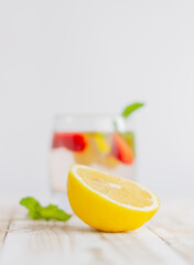 half a lemon on a light wooden table