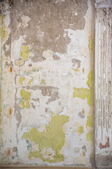 old grungy concrete wall with peeling plaster and paint